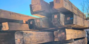 Stacks of Reclaimed Wood Timbers with a Blue Sky in the Background